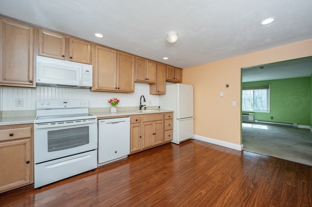 300 Swanson Road, Unit 218 Boxborough, MA 01719 - Photo 8 of 23 a kitchen with cabinets wooden floor and a sink