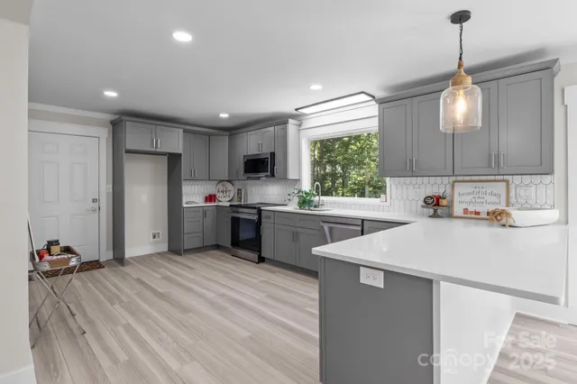 a kitchen with a refrigerator a sink and a oven