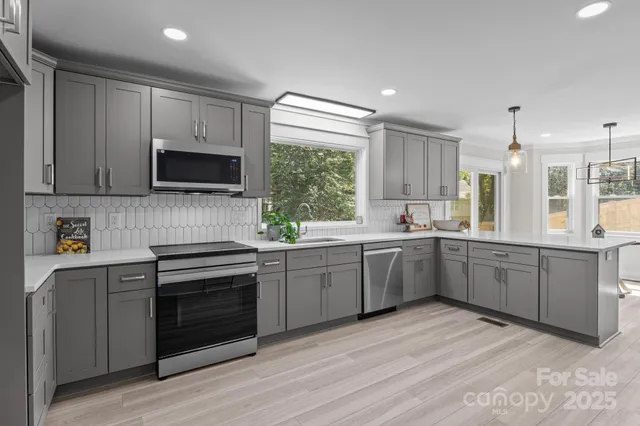 a kitchen with a stove a sink and a microwave