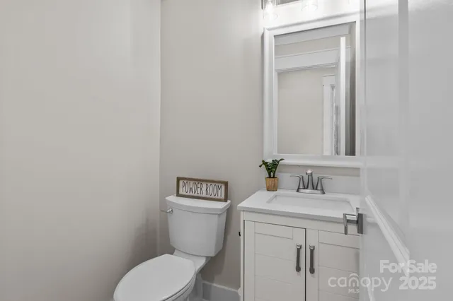 a white toilet sitting next to a bathroom sink