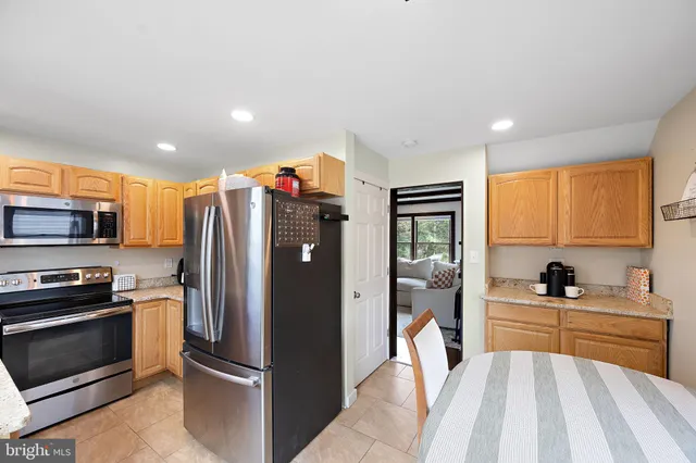 a kitchen with stainless steel appliances a refrigerator stove and sink