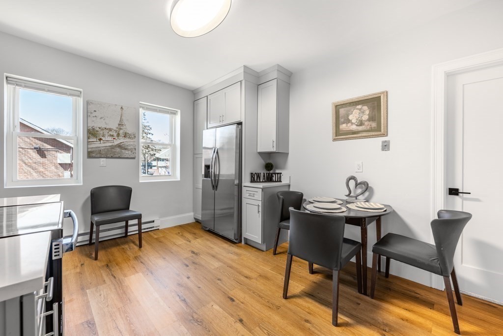 113 Regent Street Boston, MA 02119 - Photo 7 of 18 a workspace with furniture and a window