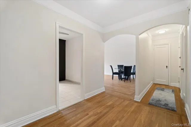 a view of a livingroom with a dinning area hardwood floor and a hallway