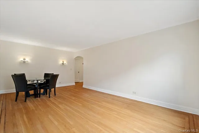 a view of a workspace with furniture and wooden floor
