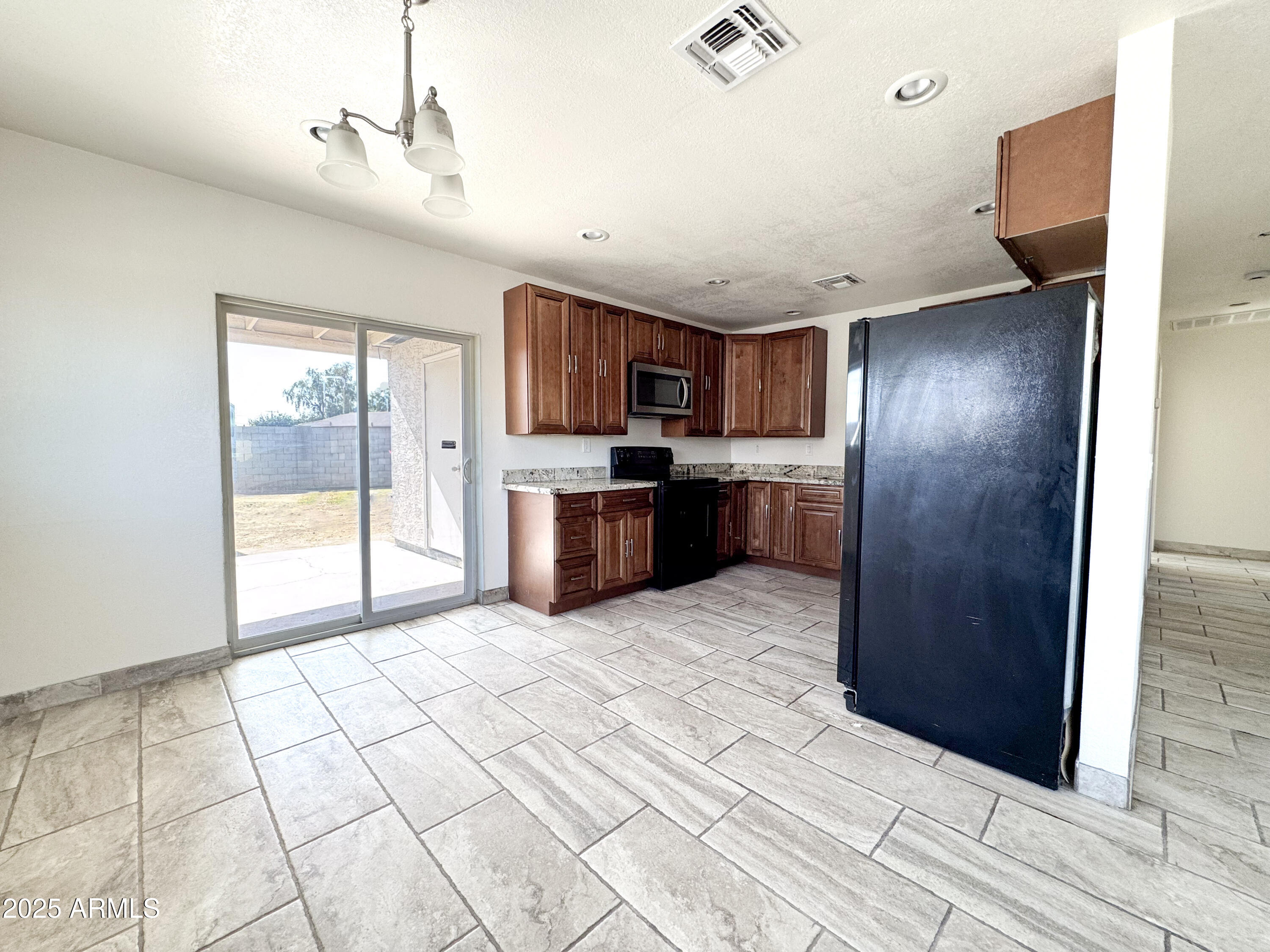 2739 West Rancho Drive Phoenix, AZ 85017 - Photo 7 of 33 a large kitchen with cabinets and stainless steel appliances