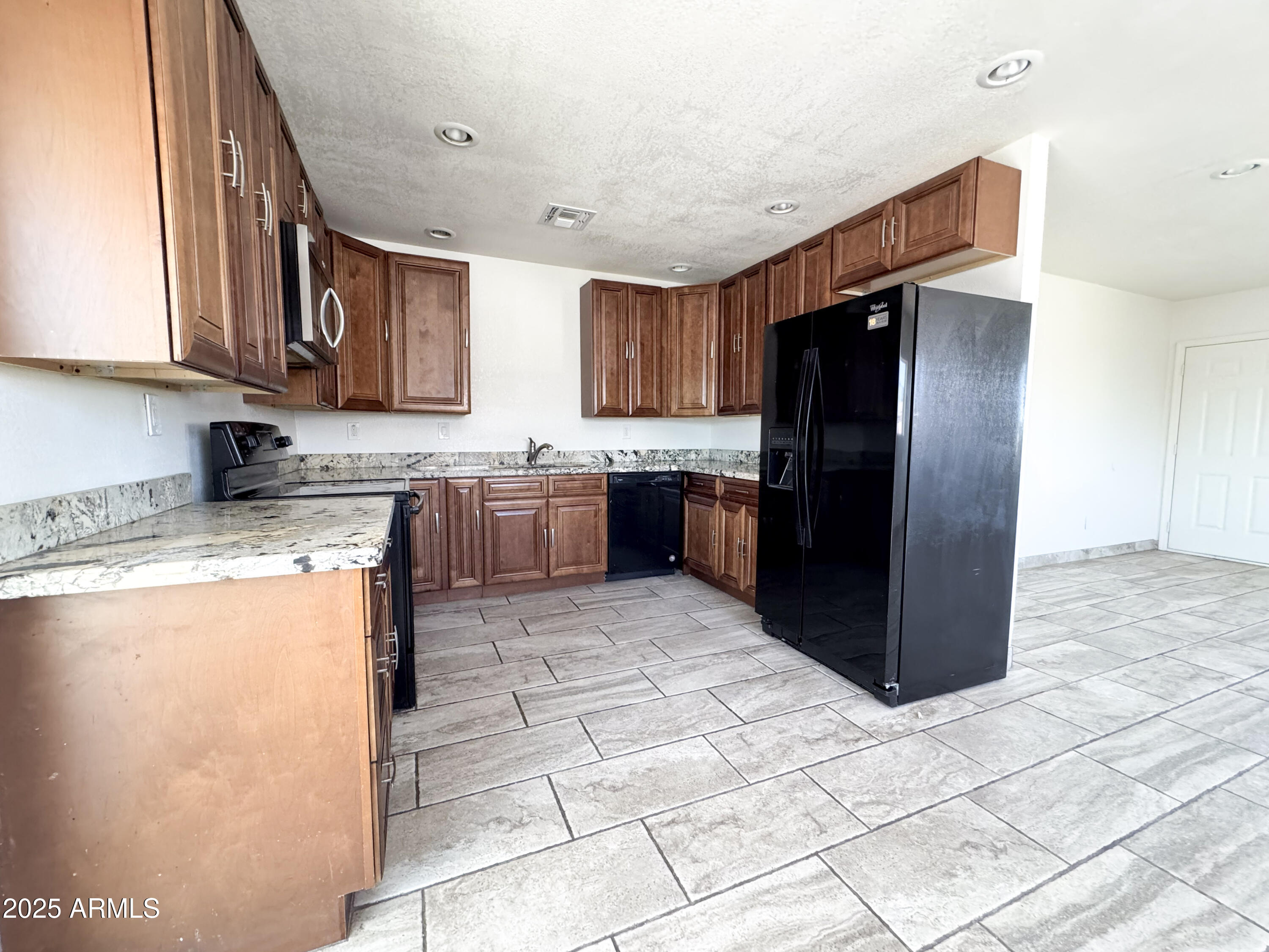 2739 West Rancho Drive Phoenix, AZ 85017 - Photo 9 of 33 a kitchen with stainless steel appliances granite countertop a refrigerator and a stove top oven