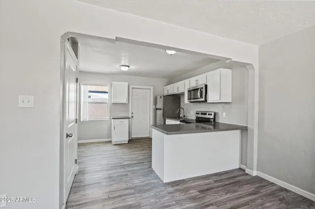 a kitchen with stainless steel appliances a white stove top oven and a refrigerator