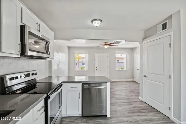 a kitchen with stainless steel appliances granite countertop a stove and a sink
