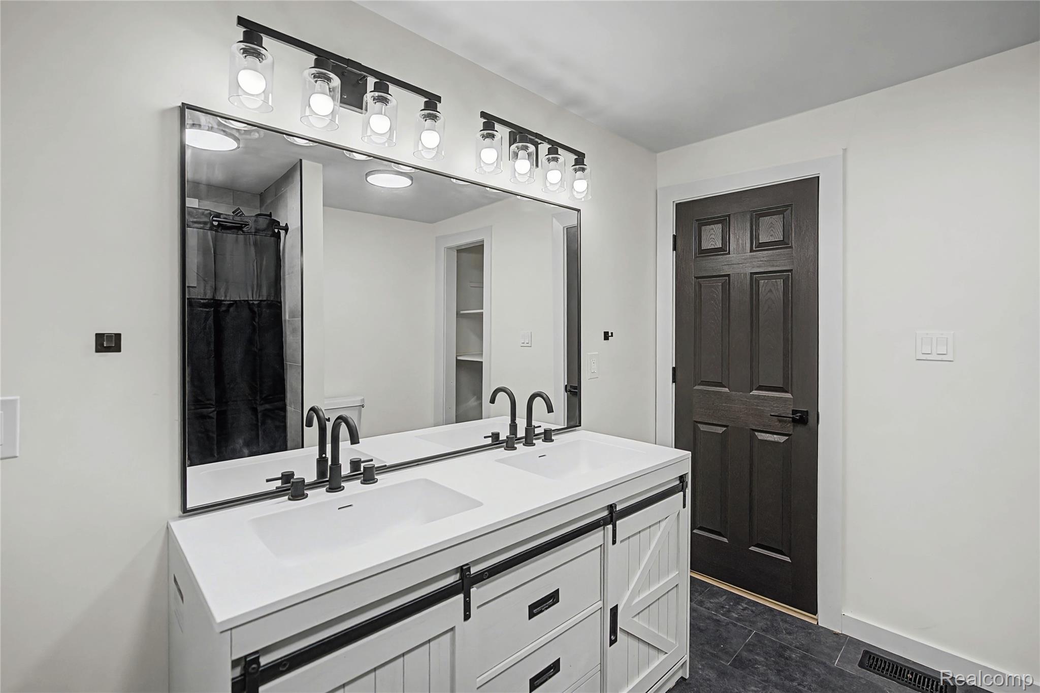 14308 North Belsay Road Millington, MI 48746 - Photo 34 of 51 Full bath with double vanity and a shower with curtain