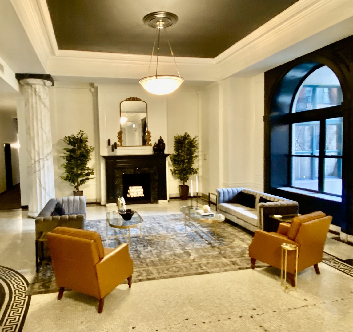 1439 South Michigan Avenue, Unit 101 Chicago, IL 60605 - Photo 2 of 14 a living room with furniture a fireplace and a large window