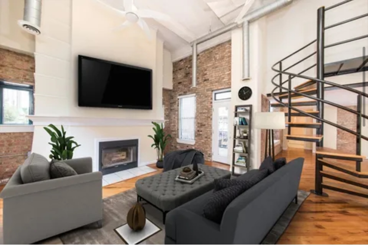 1439 South Michigan Avenue, Unit 101 Chicago, IL 60605 - Photo 3 of 14 a living room with furniture a fireplace and a flat screen tv