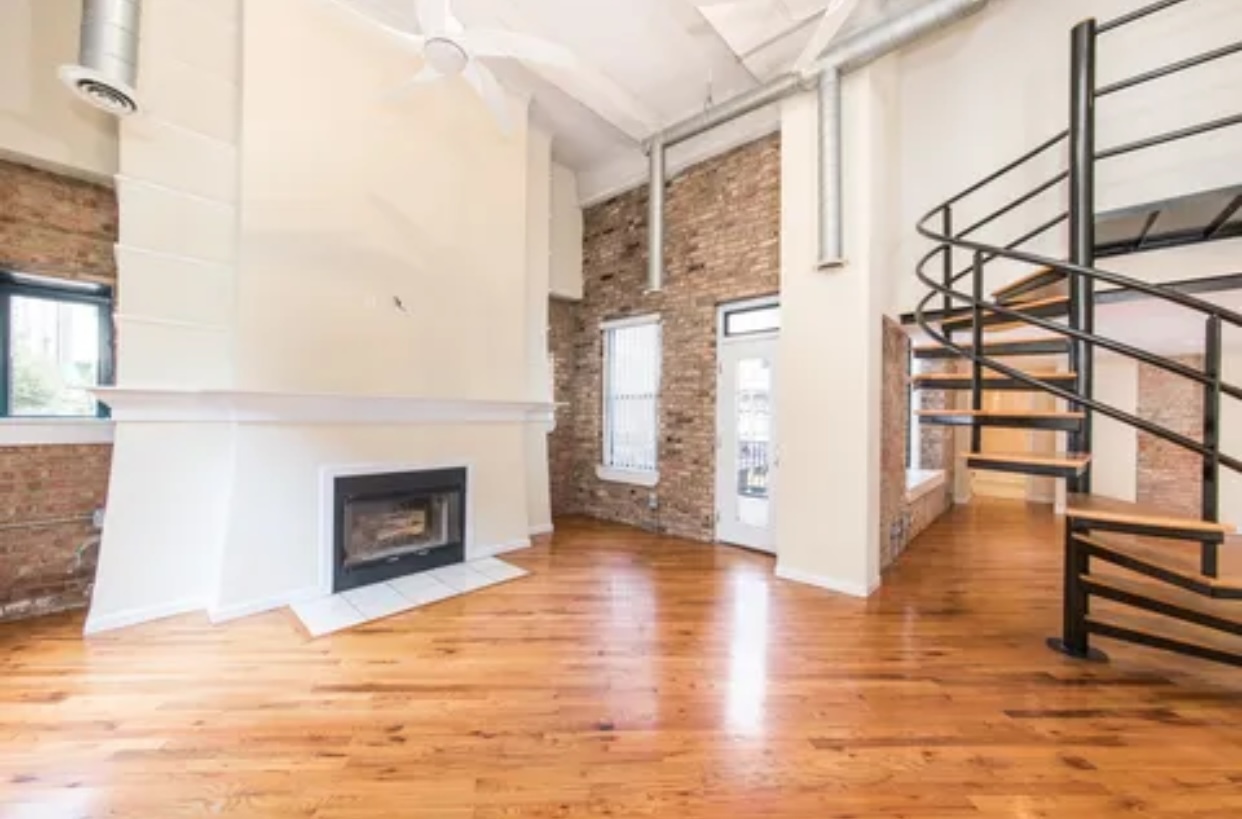 1439 South Michigan Avenue, Unit 101 Chicago, IL 60605 - Photo 4 of 14 a view of a livingroom with wooden floor and a fireplace