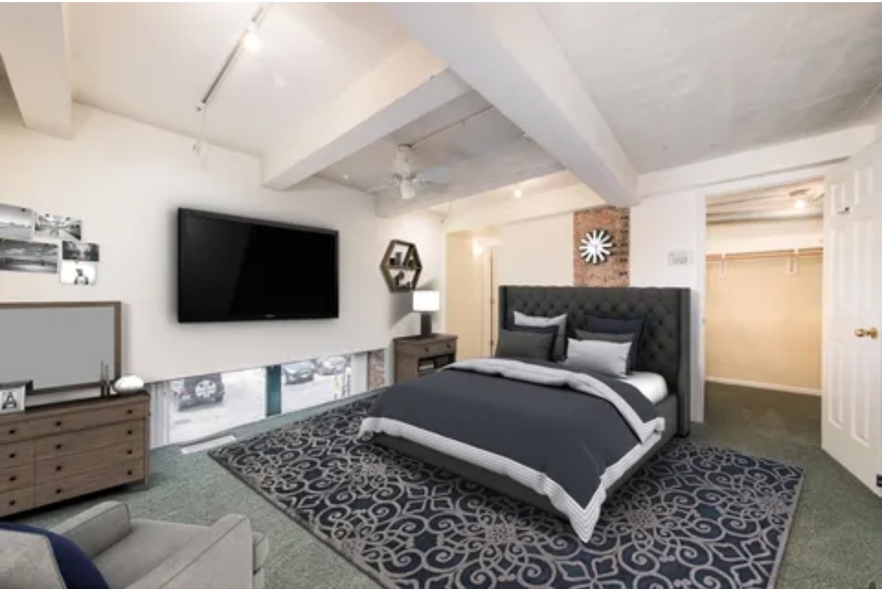 1439 South Michigan Avenue, Unit 101 Chicago, IL 60605 - Photo 9 of 14 a bedroom with a large bed and a flat screen tv