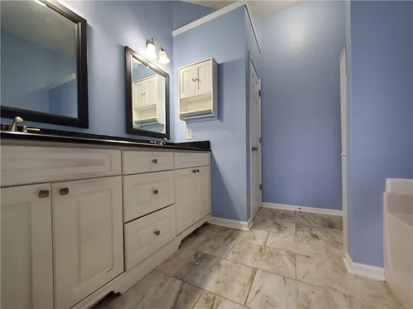 a view of bathroom with mirror and window