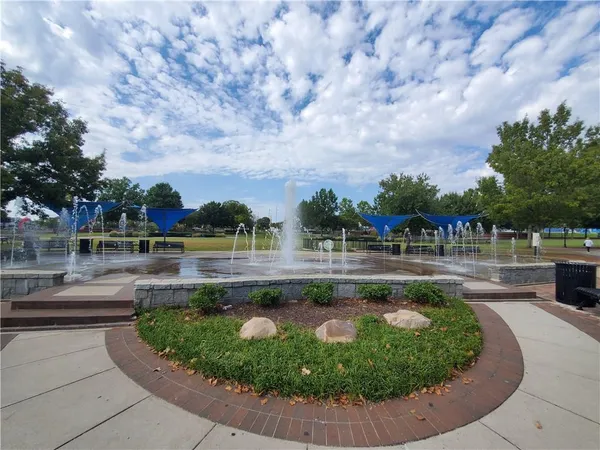 a view of swimming pool and trees in the background