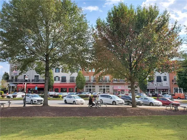 a swimming pool with outdoor seating and lots of swings and slides