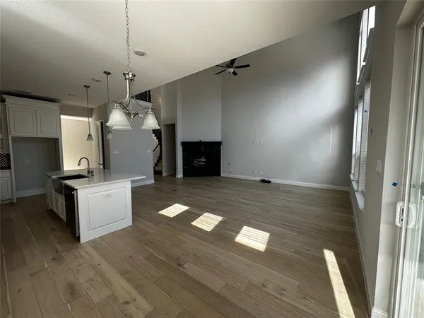a view of a hallway with entryway and wooden floor