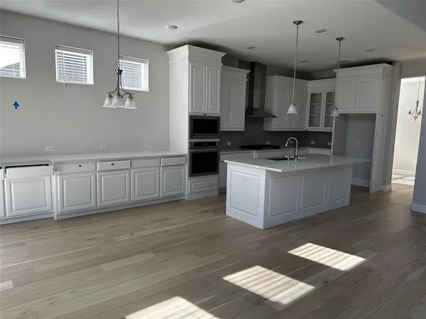 a kitchen with stainless steel appliances granite countertop a sink a stove a refrigerator and cabinets