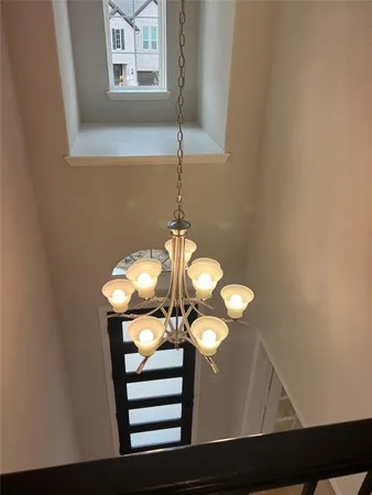 a view of a hallway with chandelier