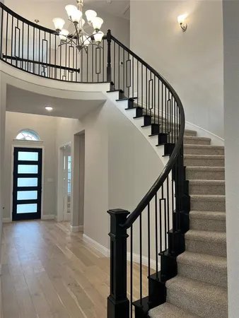 a view of staircase with wooden floor and stairs