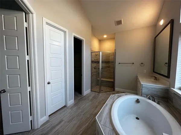 a bathroom with a sink mirror and shower