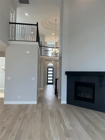 an empty room with windows and fireplace