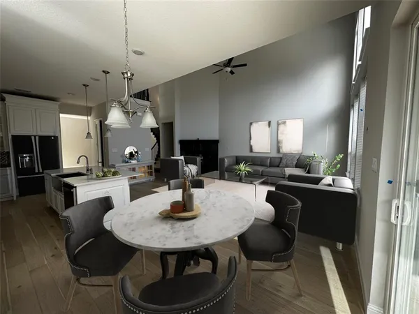 a kitchen with a table chairs and white cabinets