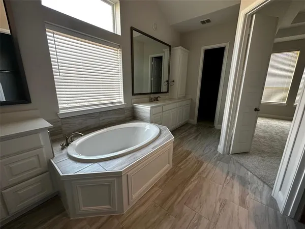 a bathroom with a sink a mirror and a bathtub