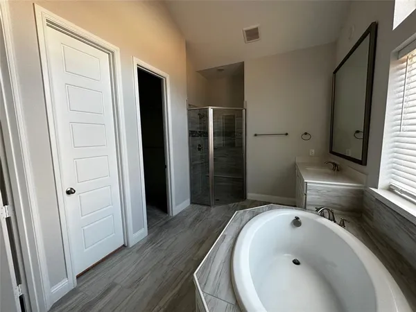 a bathroom with a bathtub and a sink