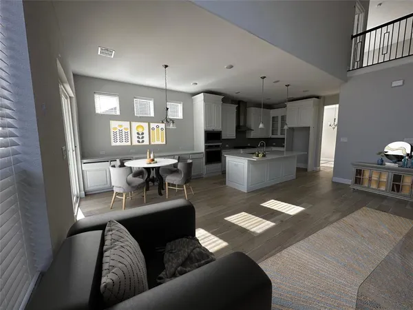 a living room with stainless steel appliances furniture and a kitchen view