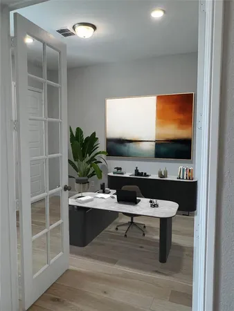 a room with furniture a flat screen tv and a potted plant