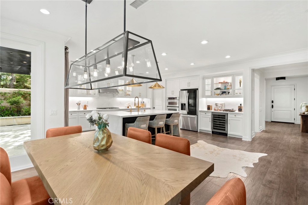 24 Tesoro Irvine, CA 92618 - Photo 34 of 75 a view of a dining room and livingroom with furniture wooden floor a chandelier