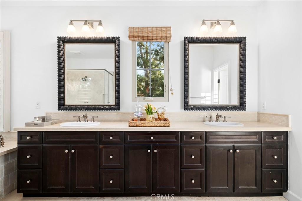 24 Tesoro Irvine, CA 92618 - Photo 47 of 75 a bathroom with a double vanity sink and a mirror