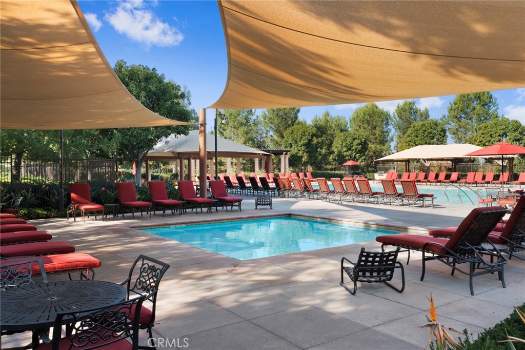 24 Tesoro Irvine, CA 92618 - Photo 61 of 75 a view of a swimming pool with a table and chairs under an umbrella