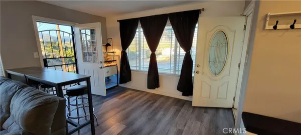 wooden floor in an entryway with a window and wooden floor