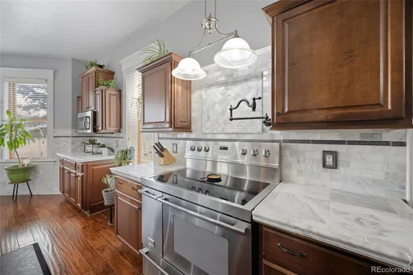 a kitchen with a sink cabinets and wooden floor