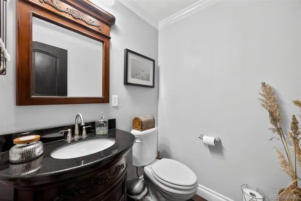 a bathroom with a sink a toilet and mirror