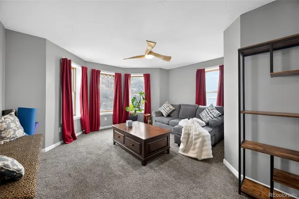 a living room with furniture and a chandelier