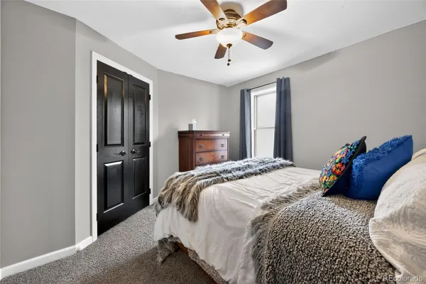 a bedroom with a bed and a chandelier