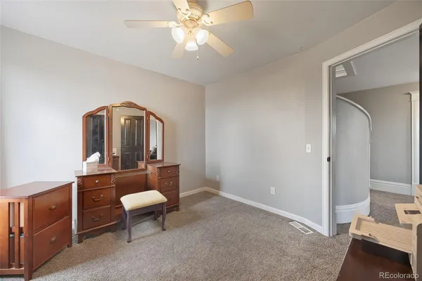 a living room with furniture and a mirror