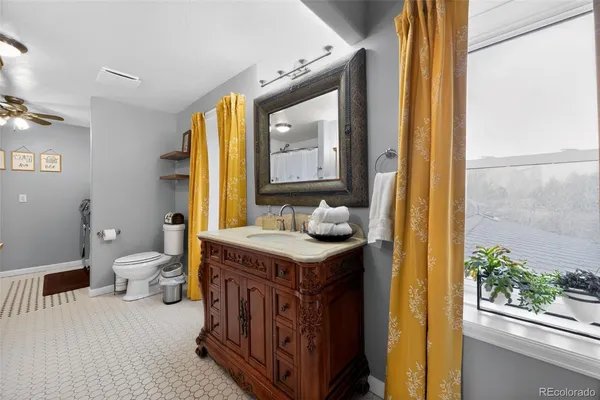 a bathroom with a sink a toilet and mirror