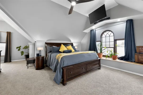 a spacious bedroom with a bed and a large window