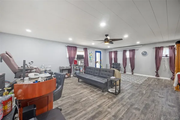 a living room with furniture and wooden floor