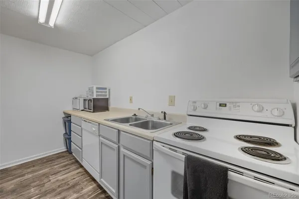 a kitchen with a sink a stove and cabinets