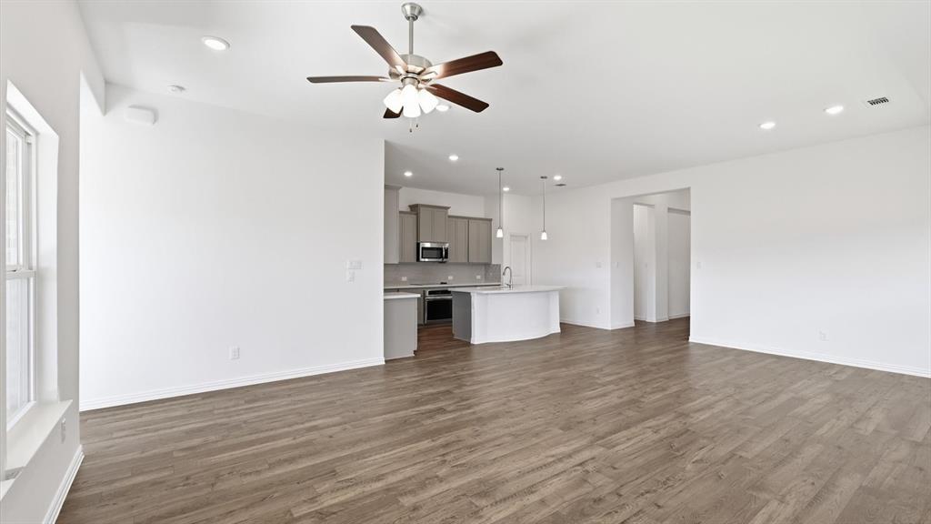 2529 Rivers W Road Anna, TX 75409 - Photo 17 of 40 Spacious open-concept living area featuring wood-finish flooring, recessed lighting, and a ceiling fan