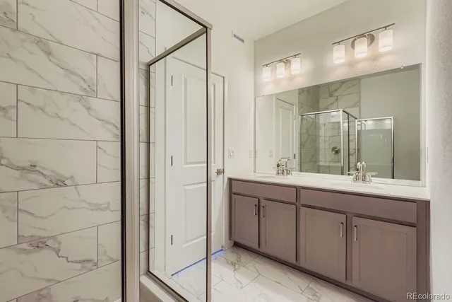 a bathroom with a double vanity sink and mirror