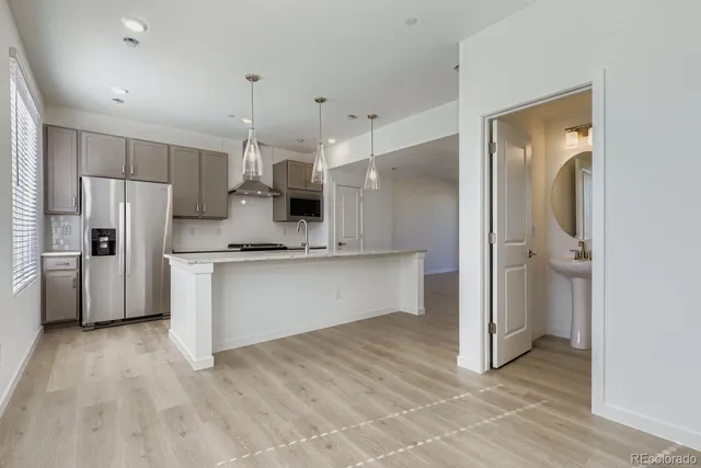 a view of kitchen with stainless steel appliances cabinets and wooden floor