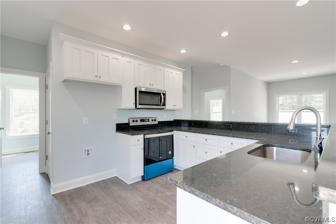 1219 Deep Run Road Cartersville, VA 23027 - Photo 10 of 26 a kitchen with stainless steel appliances granite countertop a sink a stove a microwave and a refrigerator