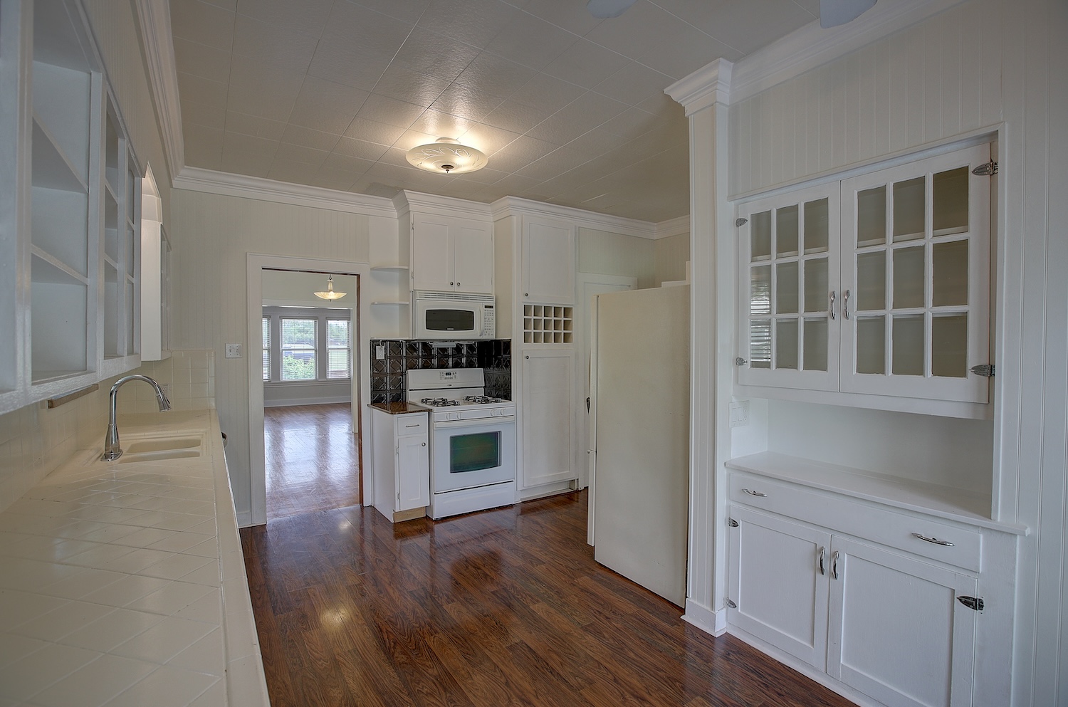 1708 Olive Street Georgetown, TX 78626 - Photo 10 of 40 a kitchen with white cabinets and stainless steel appliances