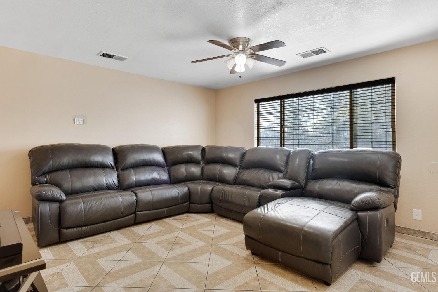 Undisclosed Address Bakersfield, CA 93307 - Photo 12 of 42 a living room with furniture and a window